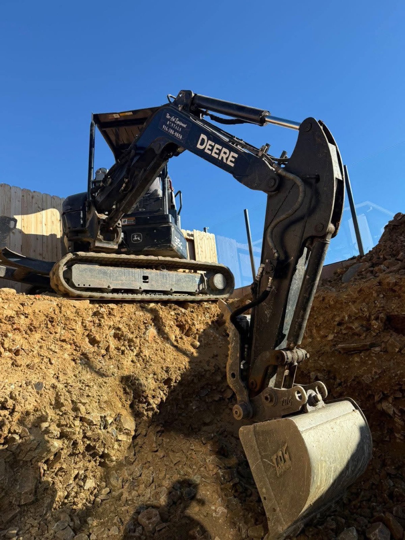 Excavator digging into foothill soil