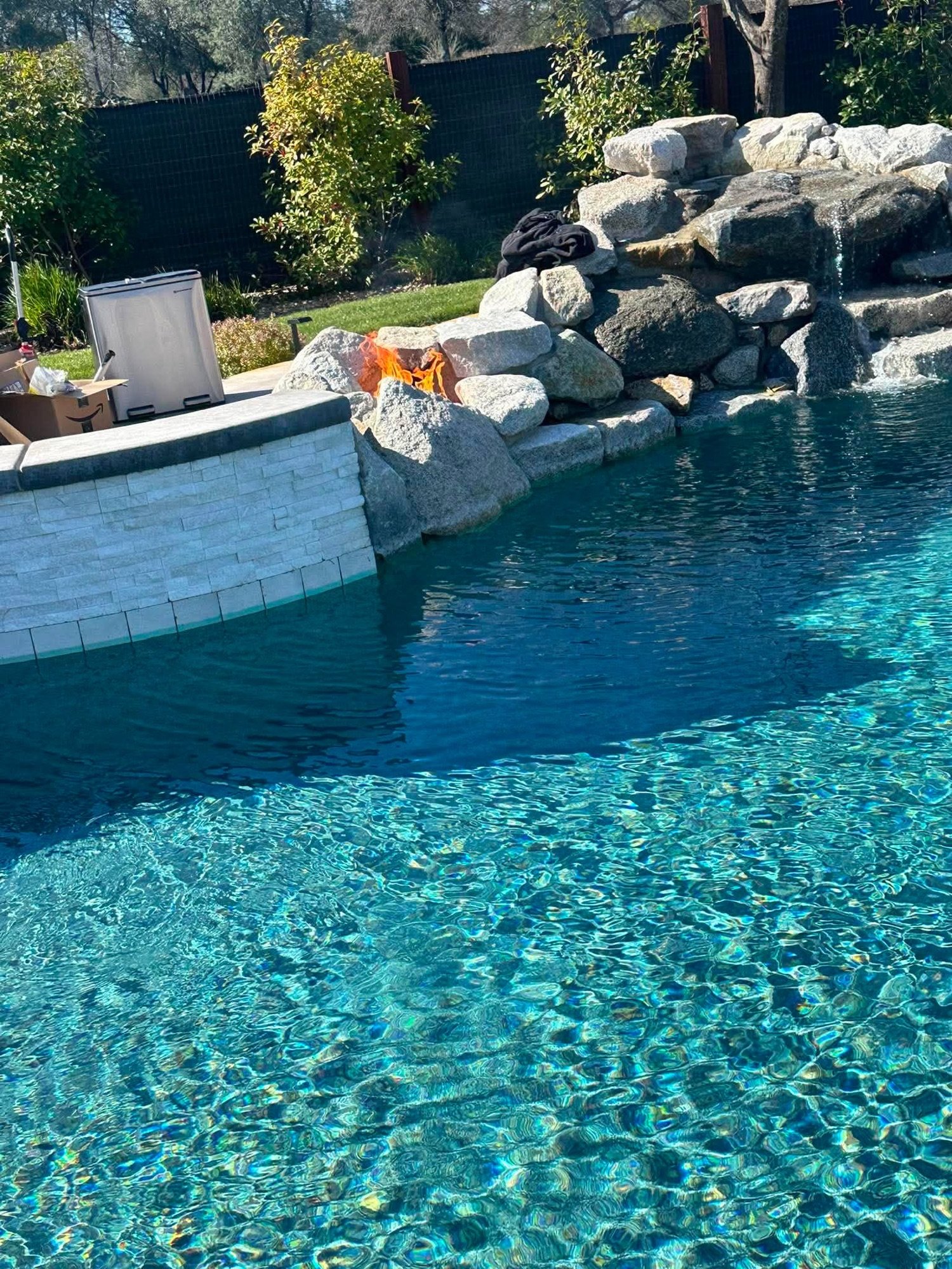 Boulder waterfall pool with slide