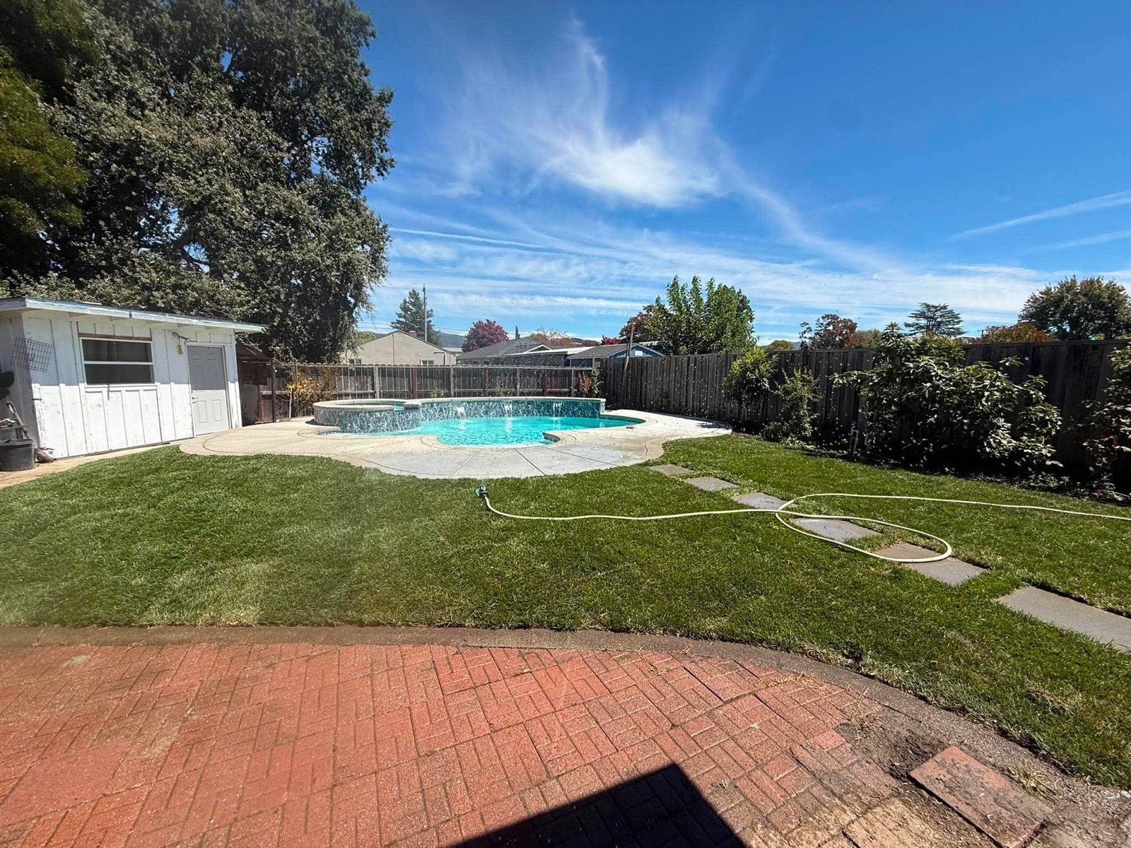 Backyard pool with a roof-mounted solar heating array
